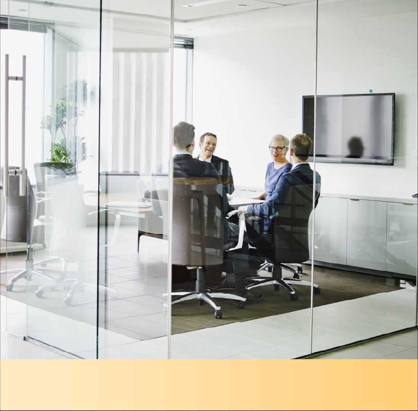 Professionals in business outfits hold a conference in a modern office room
